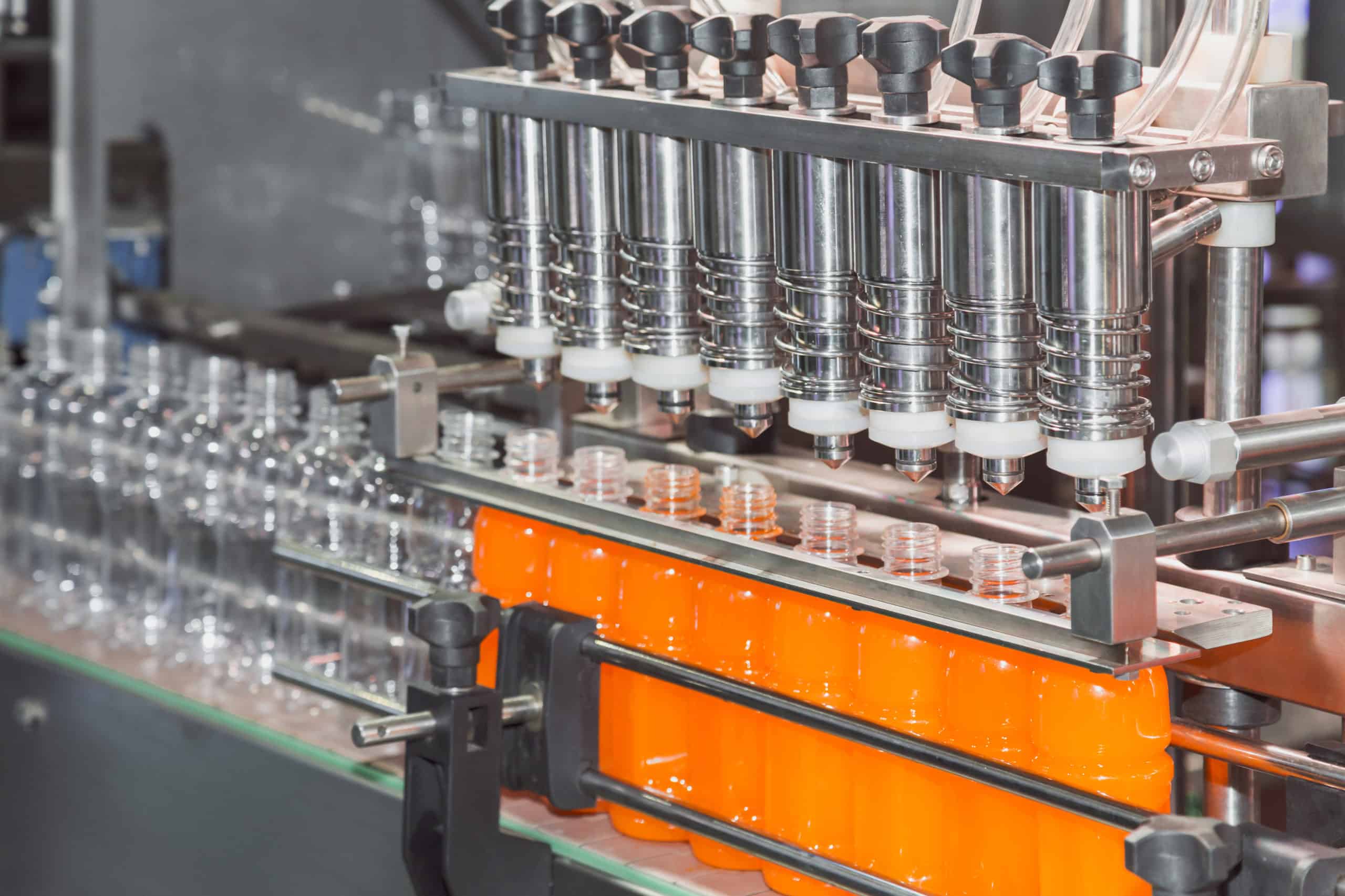 orange juice bottle on factory line machine in the factory, orange bottles transfer on conveyor belt system